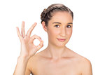 Relaxed woman making okay gesture