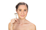 Cheerful gorgeous model holding eyelash curler