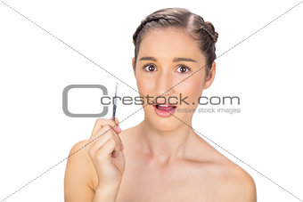 Surprised gorgeous model holding tweezers