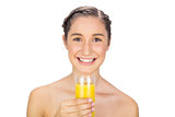Smiling gorgeous model holding glass of orange juice