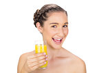 Smiling healthy model holding orange juice