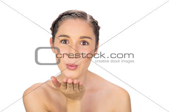 Happy healthy model sending an air kiss to camera