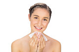 Smiling young model holding tissue