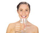 Smiling young model holding glass of water