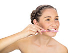 Cheerful young model brushing her teeth