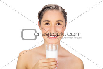 Smiling young model holding glass of milk