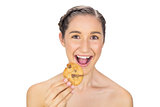 Greedy smiling model holding cookie