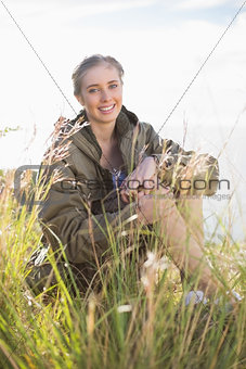 Woman sitting in grass looking at camera