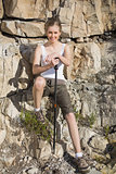 Athletic woman holding hiking pole smiling at camera