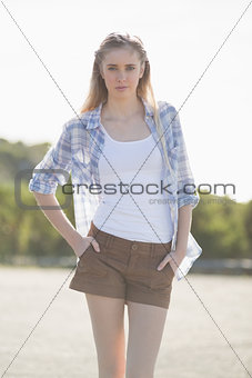 Woman posing with hands in pockets