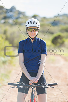 Woman with helmet sitting on bike