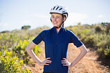 Woman with hands on hips wearing helmet