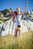Woman holding climbing equipment and showing muscle