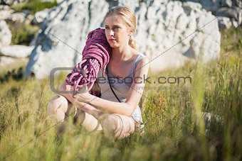Woman with climbing equipment crouching down