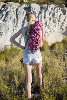 Rear view of woman holding climbing equipment