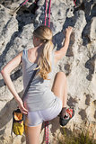 Blonde woman rock climbing