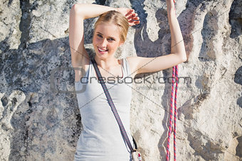 Smiling woman standing in front of rock