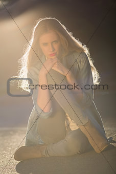 Beautiful woman sitting on road posing