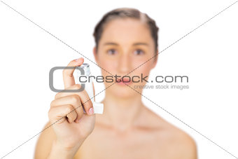 Natural young model holding asthma atomizer