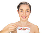 Smiling healthy model holding bowl of cereals