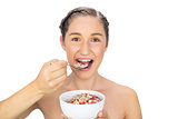 Cheerful healthy model eating cereals