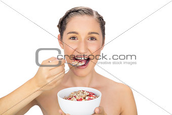 Cheerful healthy model eating cereals