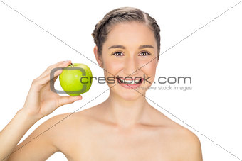 Cheerful healthy model holding green apple