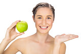 Happy healthy model holding green apple
