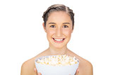 Smiling natural model holding popcorn