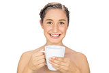 Smiling natural model holding cup of coffee