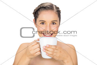 Smiling natural model drinking coffee