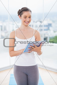 Happy sporty model scrolling on tablet pc
