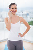 Happy sporty brunette on the phone
