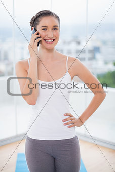 Happy sporty brunette on the phone