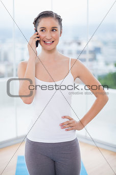 Content sporty brunette on the phone