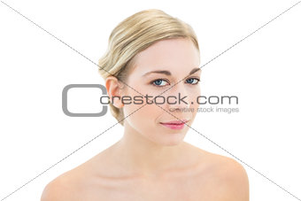 Thoughtful young blonde woman looking at camera
