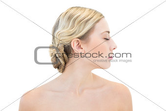 Thoughtful young blonde woman posing with closed eyes