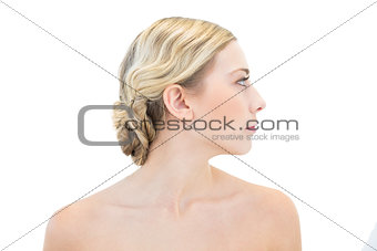 Serious young blonde woman looking away
