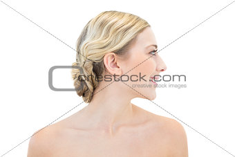 Smiling young blonde woman looking away
