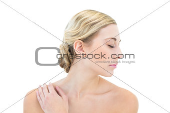 Pensive young woman posing with closed eyes