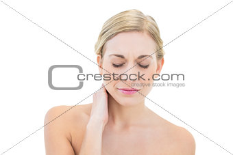 Frowning young blonde woman posing with closed eyes
