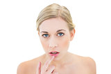 Stressed young blonde woman pointing her lip with her finger