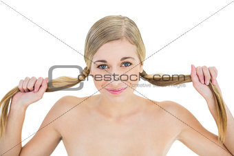 Content young blonde woman holding her pigtails