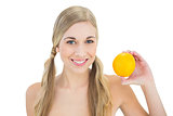 Content young blonde woman holding an orange