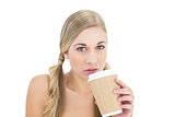 Serious young blonde woman drinking coffee