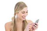 Laughing young blonde woman using a mobile phone