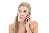 Serious young blonde woman making a phone call