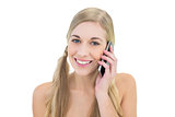Smiling young blonde woman making a phone call