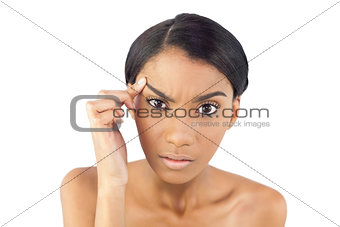 Gorgeous woman examining her eyebrow