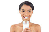 Smiling attractive model holding glass of milk